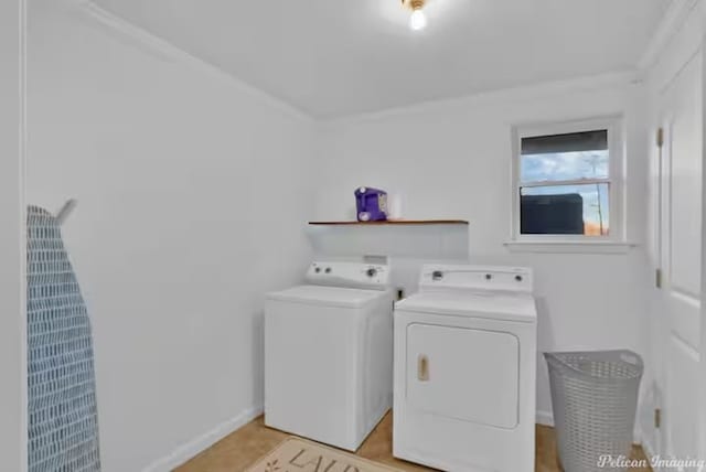 clothes washing area with crown molding and washer and dryer