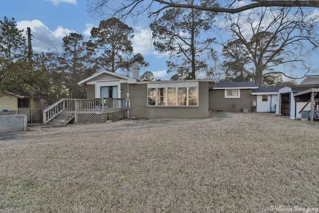 view of front of home with a wooden deck and a front yard