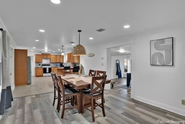 dining room with light hardwood / wood-style flooring