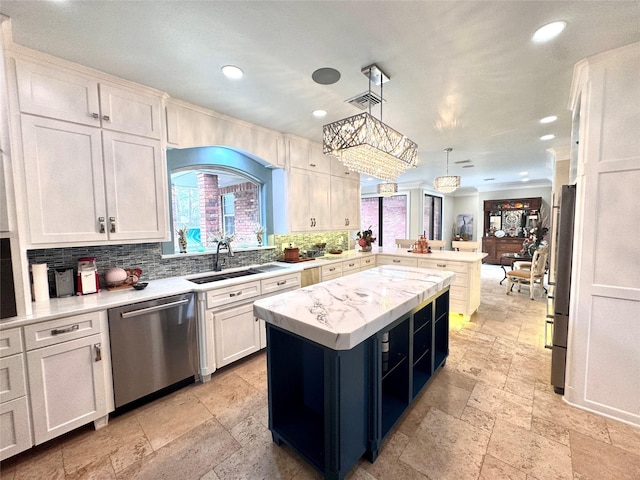 kitchen with white cabinetry, tasteful backsplash, decorative light fixtures, a center island, and stainless steel appliances