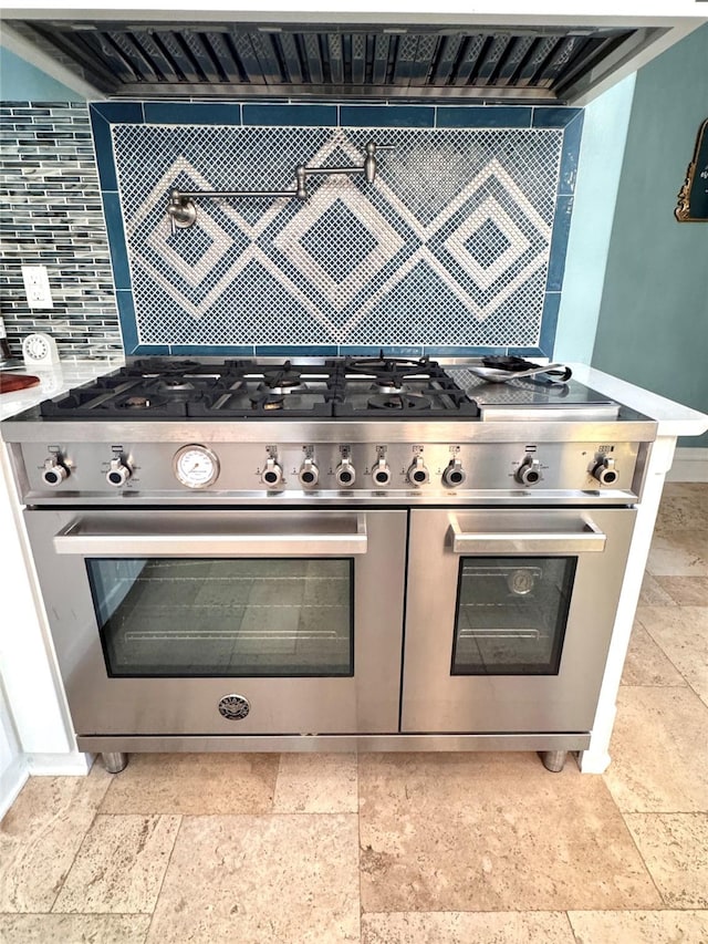 kitchen featuring double oven range and decorative backsplash