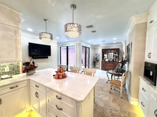 kitchen with white cabinetry, ornamental molding, decorative backsplash, and pendant lighting