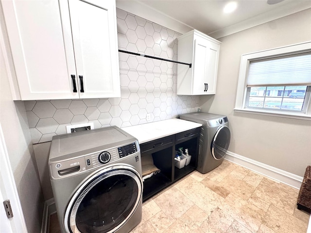 laundry area with crown molding, cabinets, and washer and clothes dryer