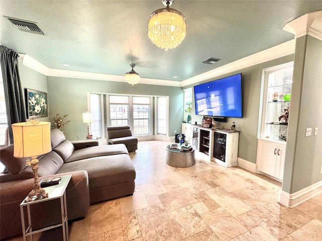 living room featuring ornamental molding and a notable chandelier