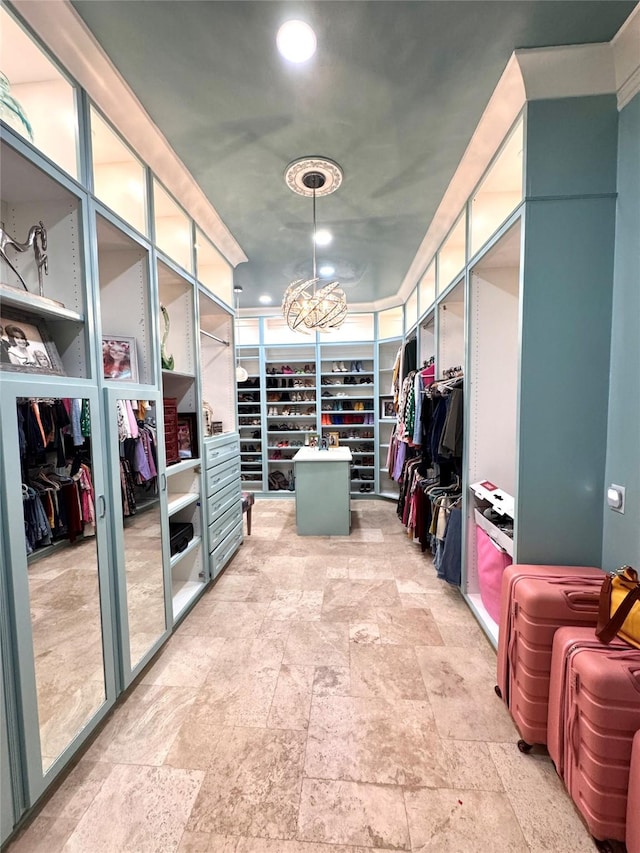 walk in closet featuring a chandelier