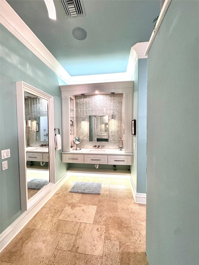 bathroom featuring vanity, backsplash, and crown molding