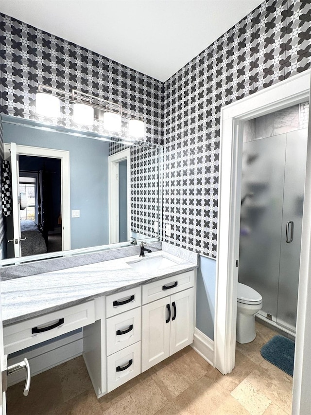 bathroom with vanity, toilet, and walk in shower