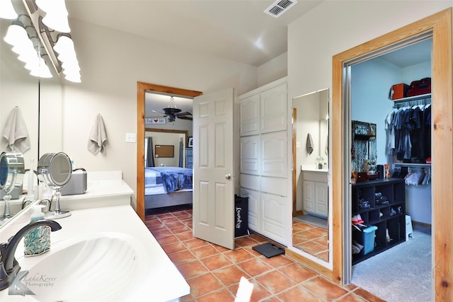 bathroom featuring vanity, ceiling fan with notable chandelier, and tile patterned floors