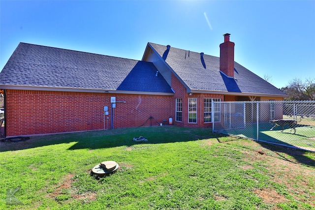 rear view of house with a yard