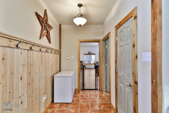 hall featuring light tile patterned floors