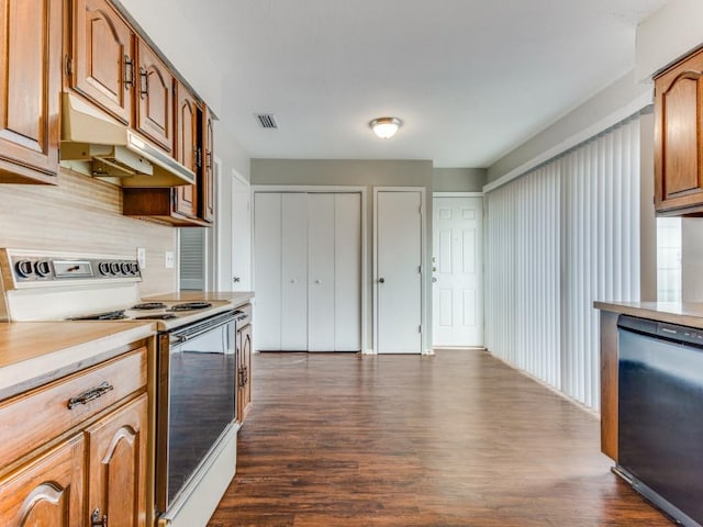 kitchen featuring tasteful backsplash, black dishwasher, dark hardwood / wood-style floors, and electric stove