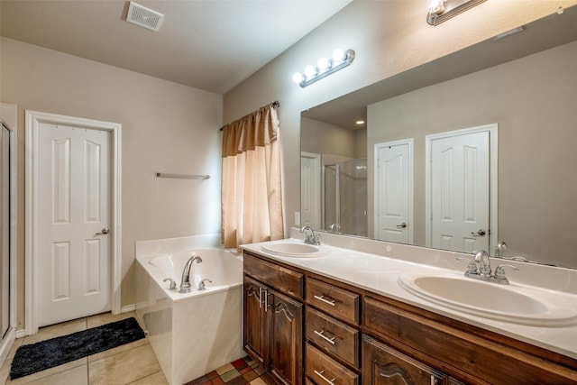 bathroom featuring tile patterned floors, vanity, and separate shower and tub