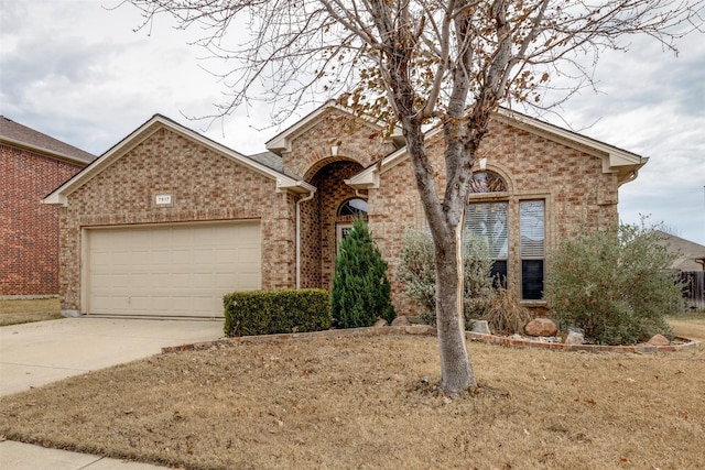 view of front of house with a garage and a front yard