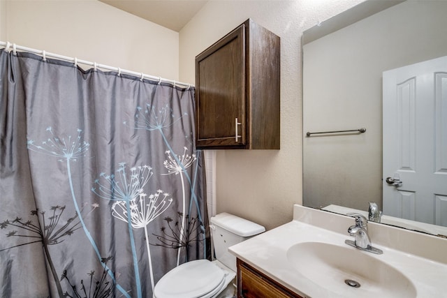 bathroom with vanity, walk in shower, and toilet