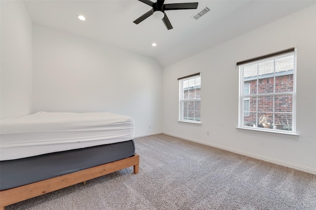 bedroom with vaulted ceiling, ceiling fan, and carpet floors