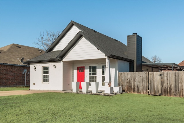 rear view of house with a lawn