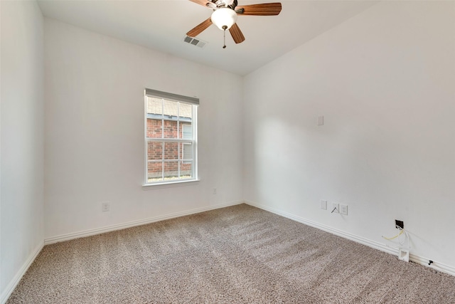 carpeted spare room with ceiling fan