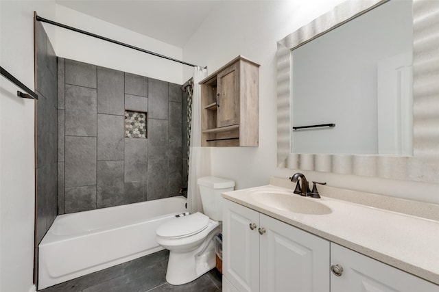 full bathroom featuring tiled shower / bath, vanity, and toilet