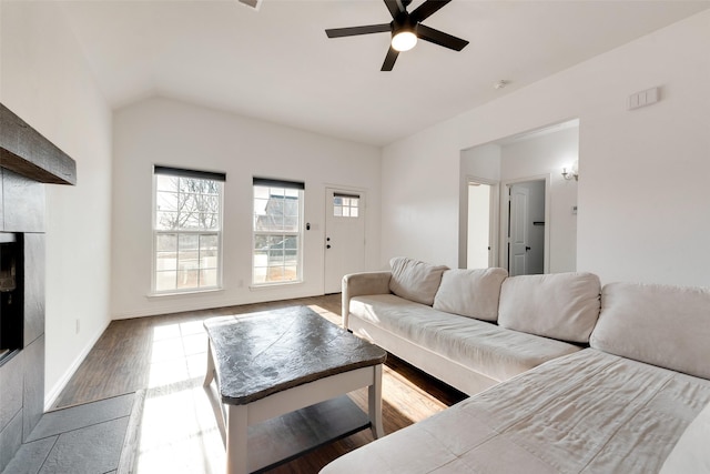 living room with hardwood / wood-style flooring, ceiling fan, and lofted ceiling