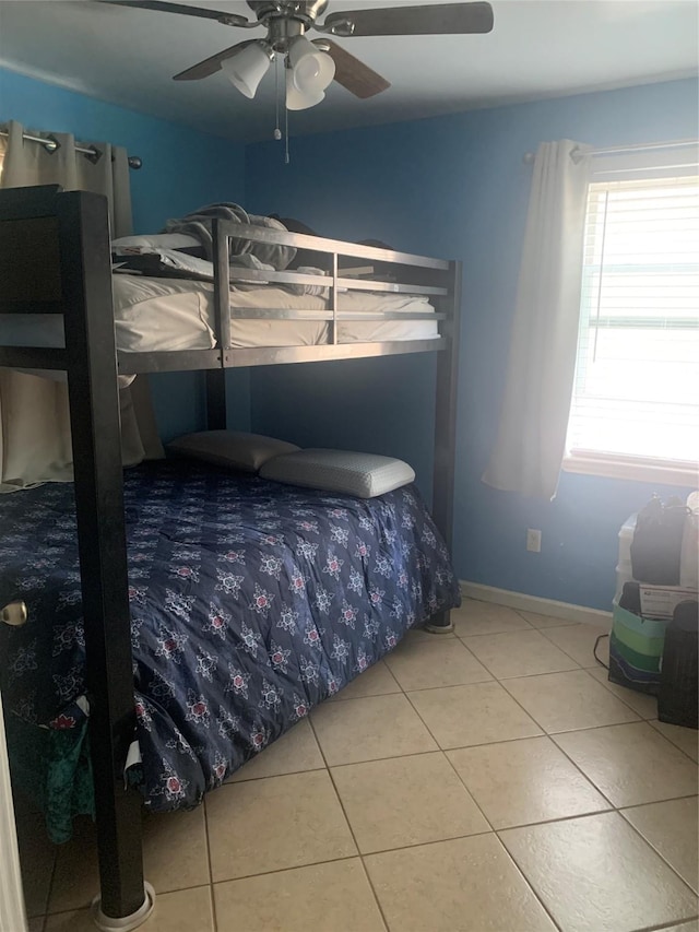 tiled bedroom with ceiling fan