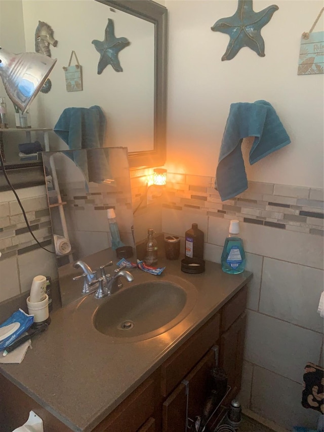 bathroom featuring vanity and tile walls