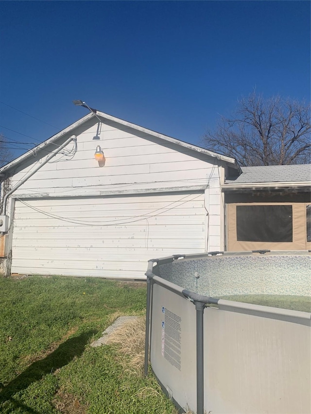 view of side of home with a yard