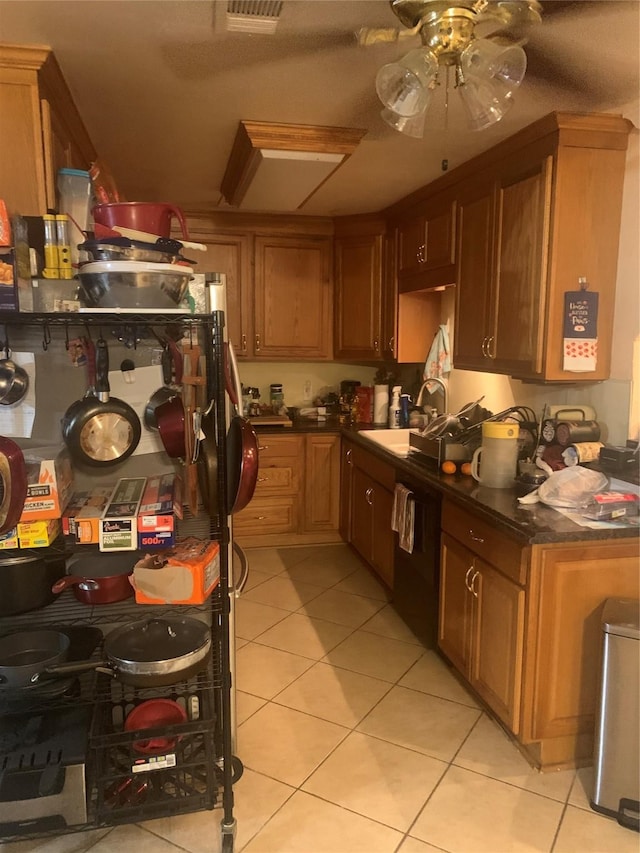 kitchen with black dishwasher, sink, ceiling fan, and light tile patterned floors