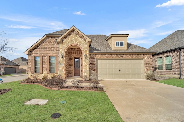 view of front of house featuring a garage and a front yard