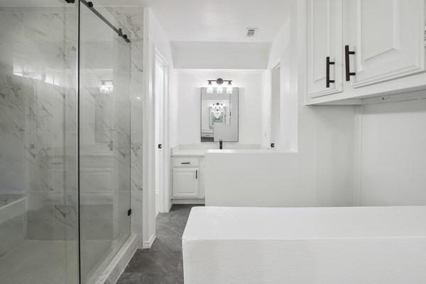 bathroom featuring vanity and an enclosed shower