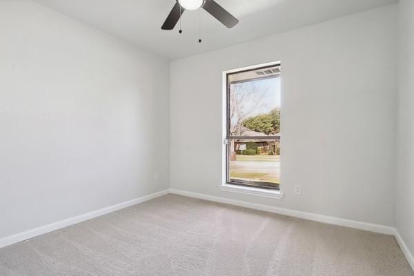 unfurnished room with ceiling fan, carpet, and a wealth of natural light