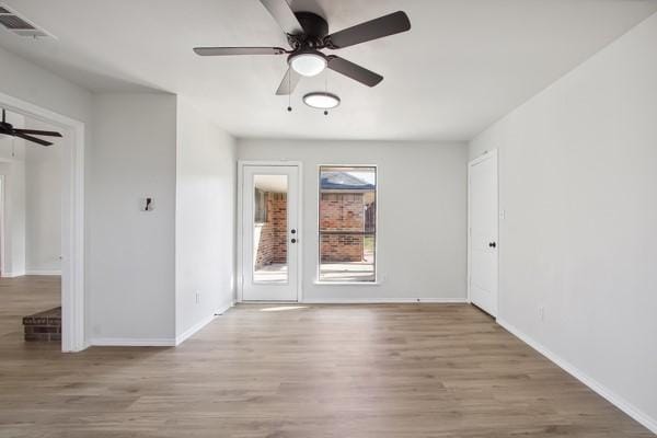 spare room featuring light hardwood / wood-style floors and ceiling fan