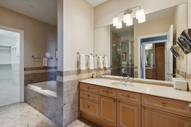 bathroom featuring vanity and separate shower and tub