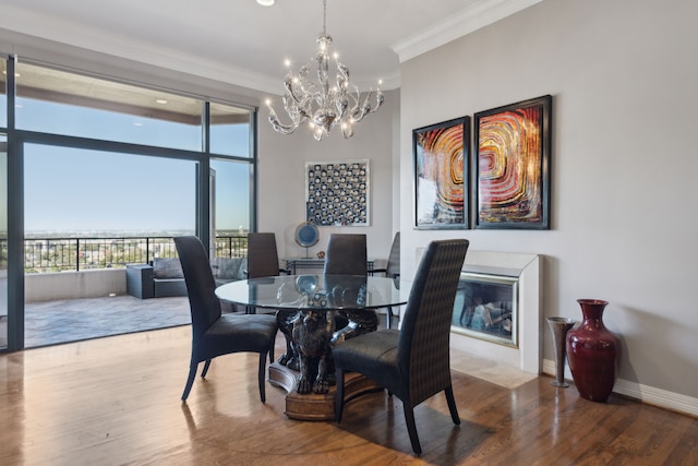 dining area featuring a notable chandelier, crown molding, and hardwood / wood-style flooring