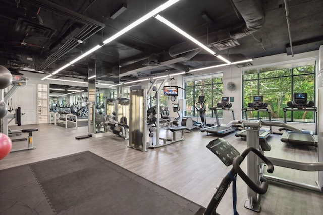 workout area with wood-type flooring