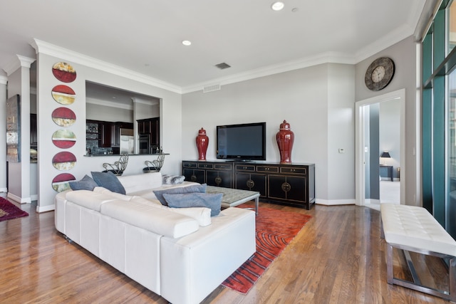 living room featuring crown molding and wood-type flooring