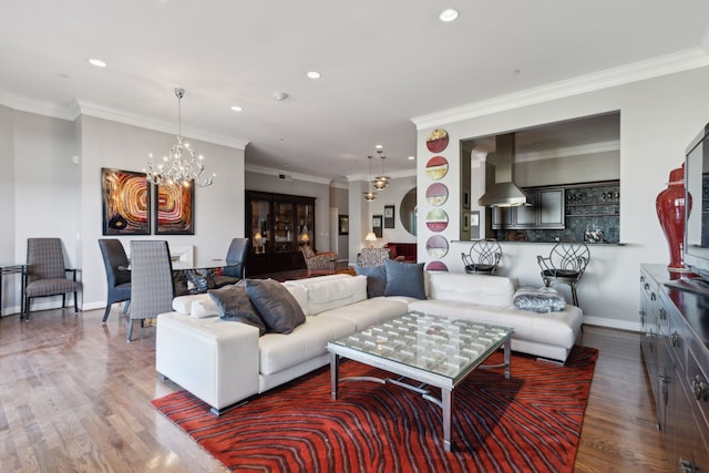 living room with crown molding, a chandelier, and hardwood / wood-style floors