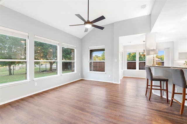 unfurnished living room with lofted ceiling, dark wood-type flooring, and ceiling fan