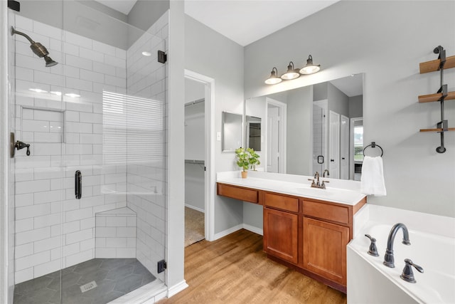 bathroom with vanity, wood-type flooring, and separate shower and tub