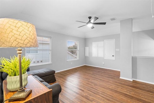 living room featuring lofted ceiling, dark hardwood / wood-style floors, and ceiling fan