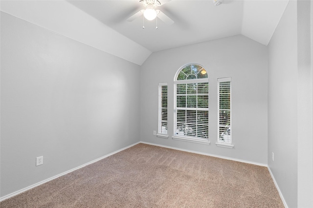 carpeted spare room with ceiling fan and lofted ceiling