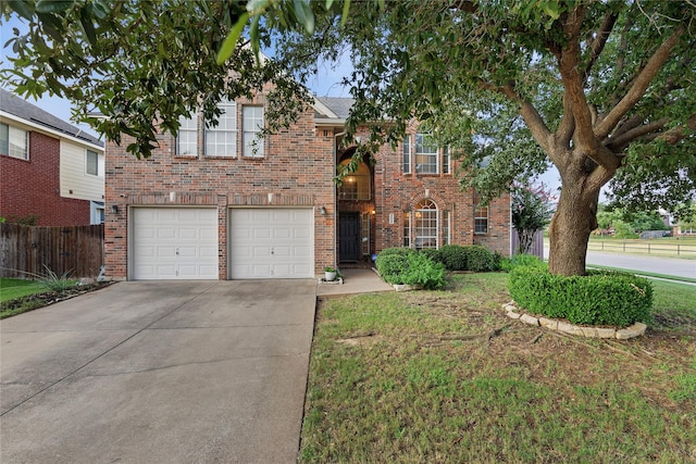 view of front of house with a garage and a front yard