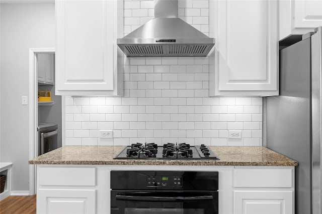 kitchen with white cabinetry, extractor fan, light stone counters, and black appliances