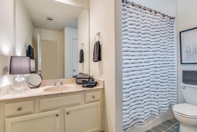 bathroom featuring tile patterned floors, vanity, toilet, and curtained shower