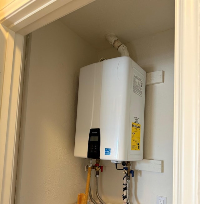 utility room with tankless water heater