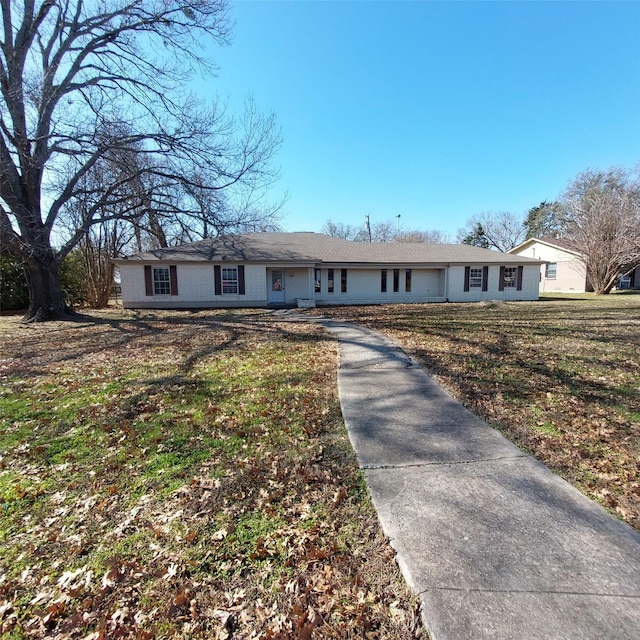 ranch-style house with a front lawn