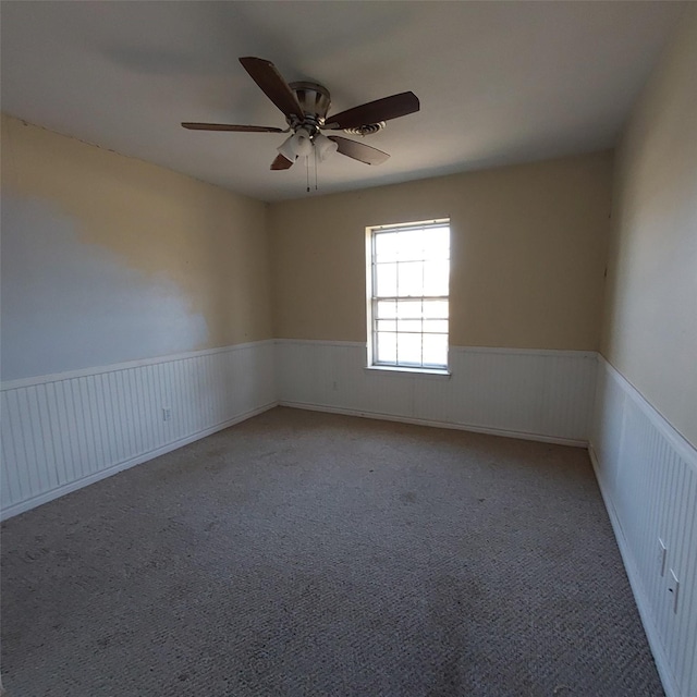 spare room featuring ceiling fan and carpet flooring