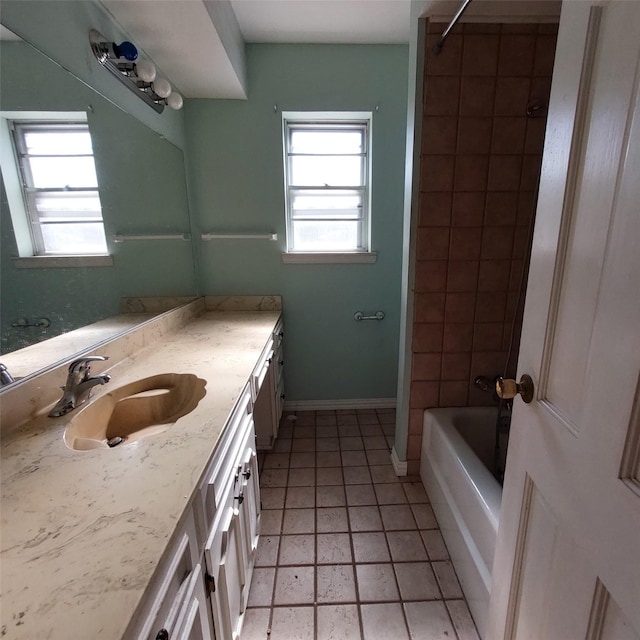 bathroom with vanity and tiled shower / bath