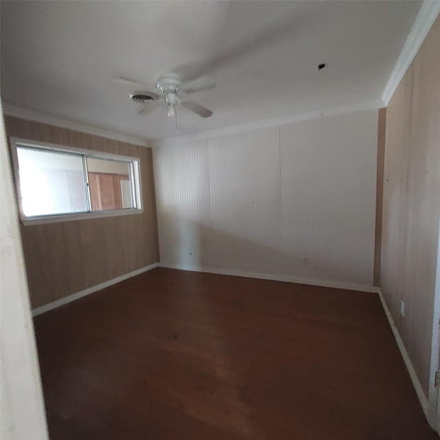 spare room featuring crown molding, ceiling fan, and dark hardwood / wood-style flooring