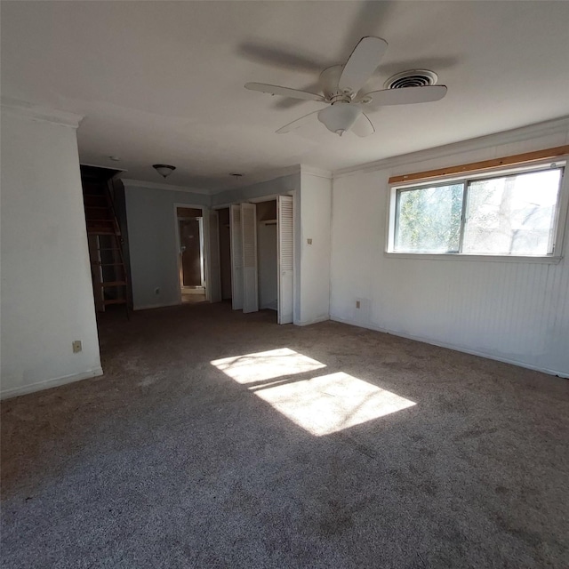 spare room with crown molding and carpet