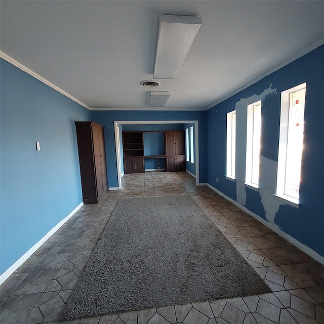 spare room featuring crown molding